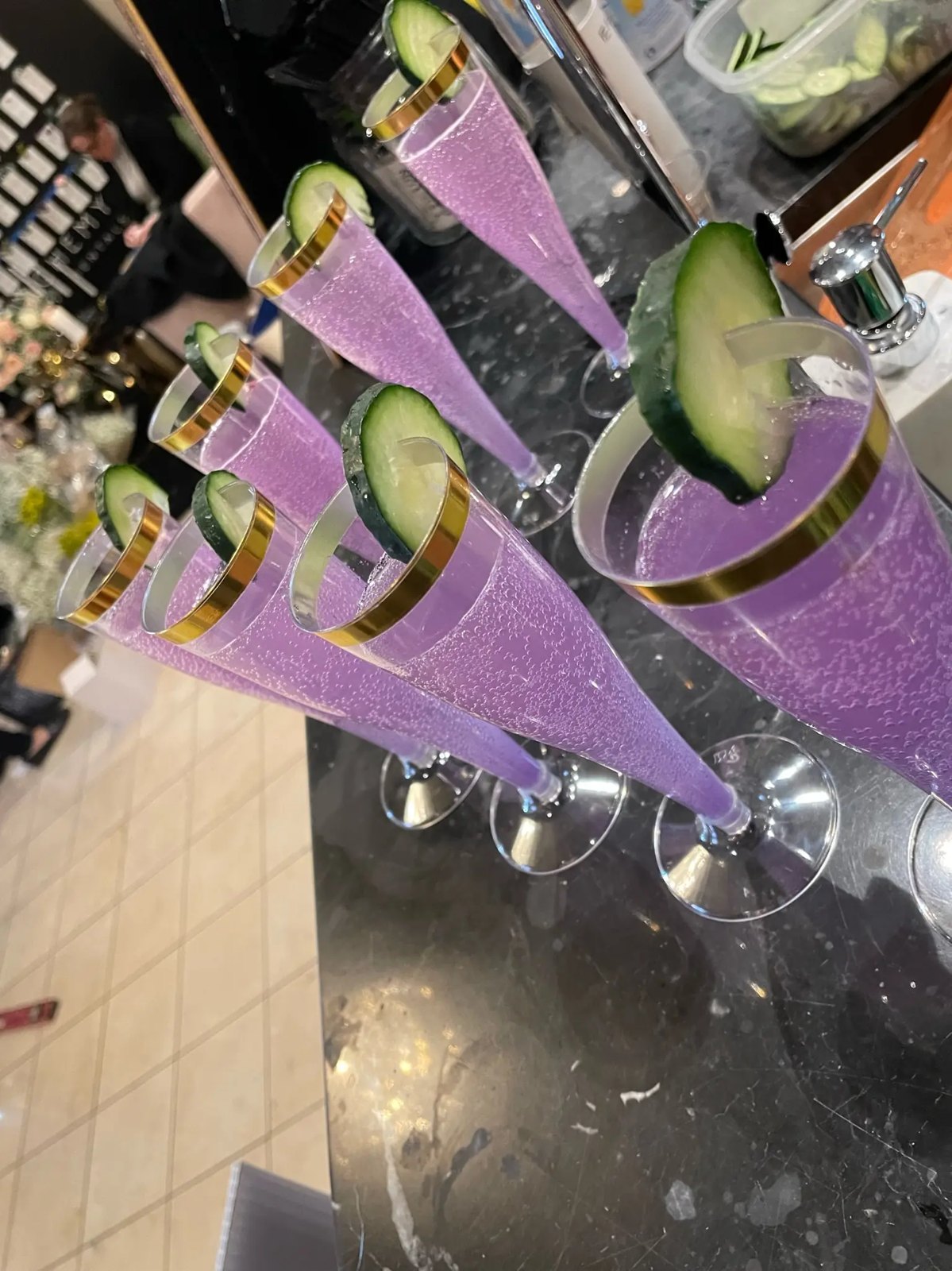 Lavender champagne flutes garnished with cucumber ribbons