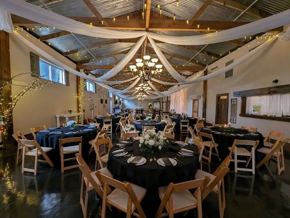 A draped ballroom set for a fundraiser gala